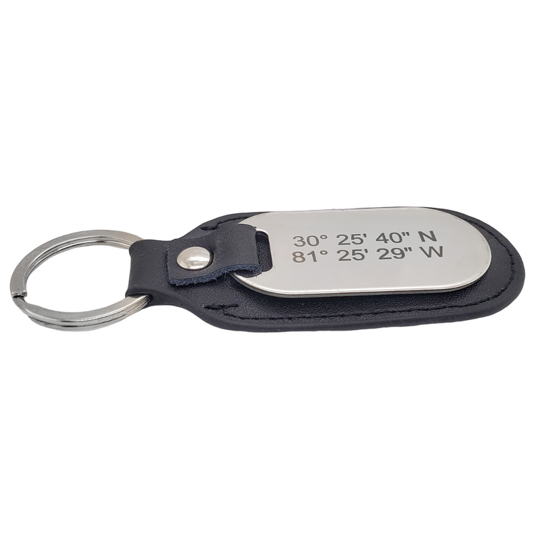 Picture of top view of black leather and stainless steel key chain that is custom inscribed with latitude longitude coordinates. By Lat & Lo. Available at latandlo.com